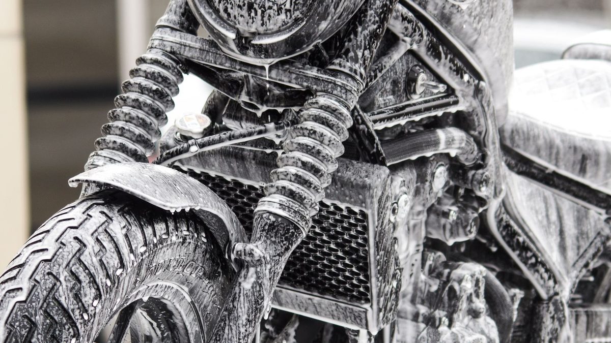 Motorcycle gear care and maintenance showing cleaning and waterproofing of touring equipment