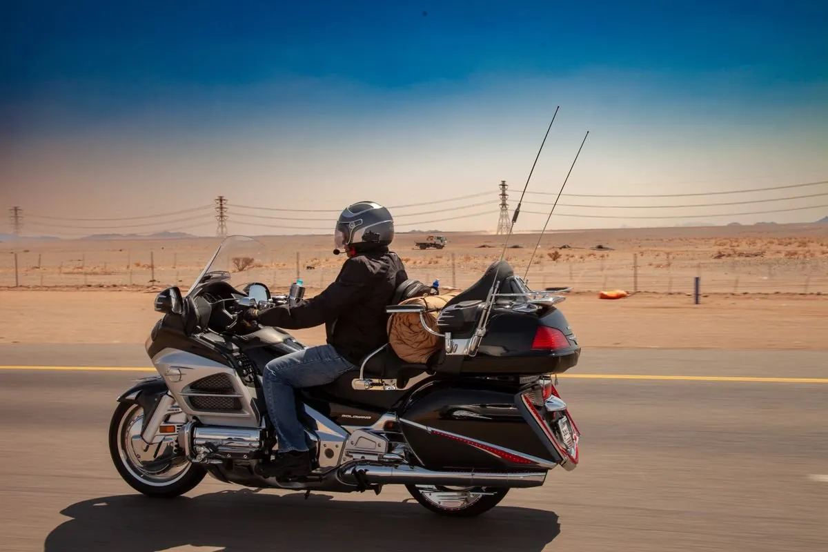 Motorcyclist riding cruiser across New Brunswick backroads