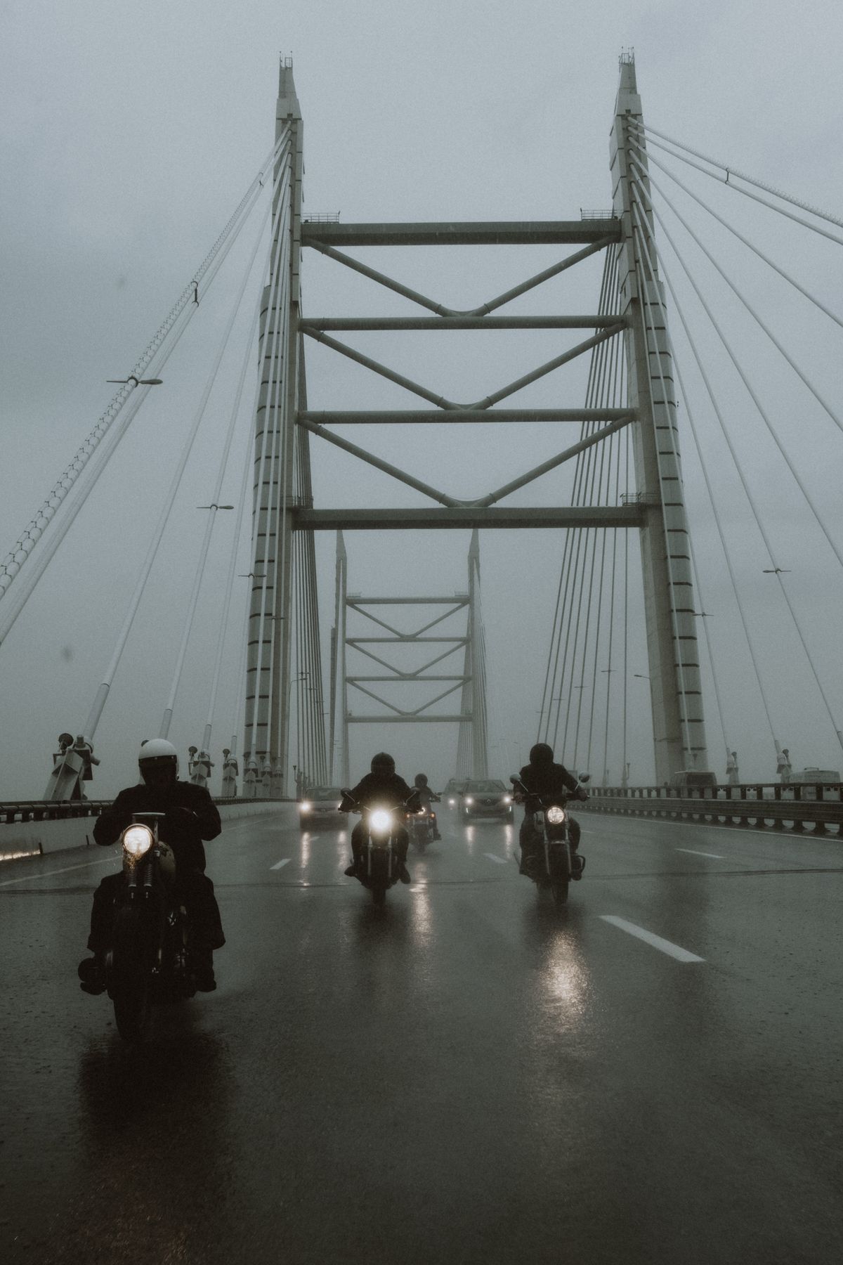 Motorcyclist paused on a scenic road contemplating whether to ride
