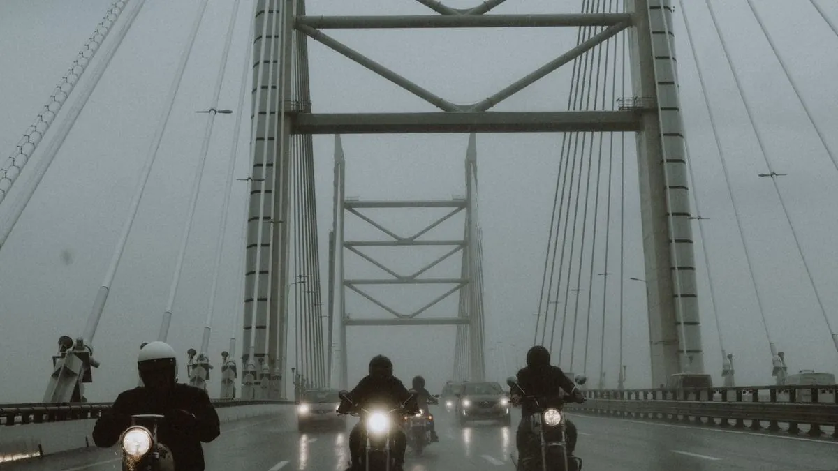 Motorcyclist paused on a scenic road contemplating whether to ride