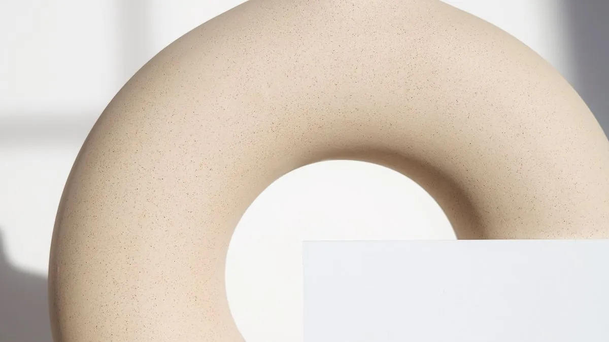 Wireless earbuds on a dark surface representing Apple's upcoming AirPods Pro with infrared cameras