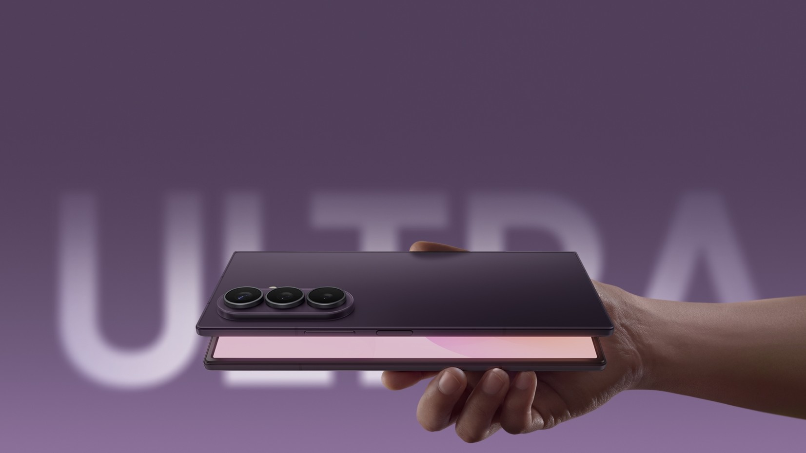 Close-up of a hand holding a foldable smartphone with a large open display