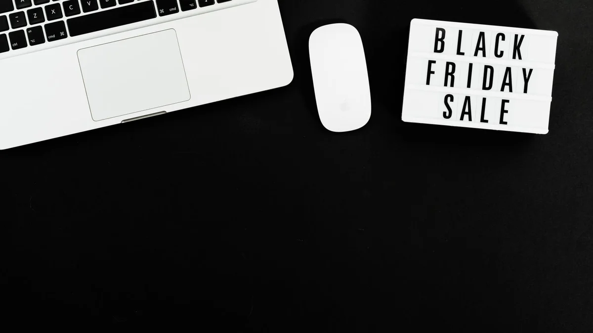 Laptop with a Black Friday sale sign on a dark background representing rising tech prices from US-Canada tariffs in 2026